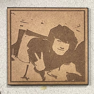 A laser engraving of my friend holding peace signs